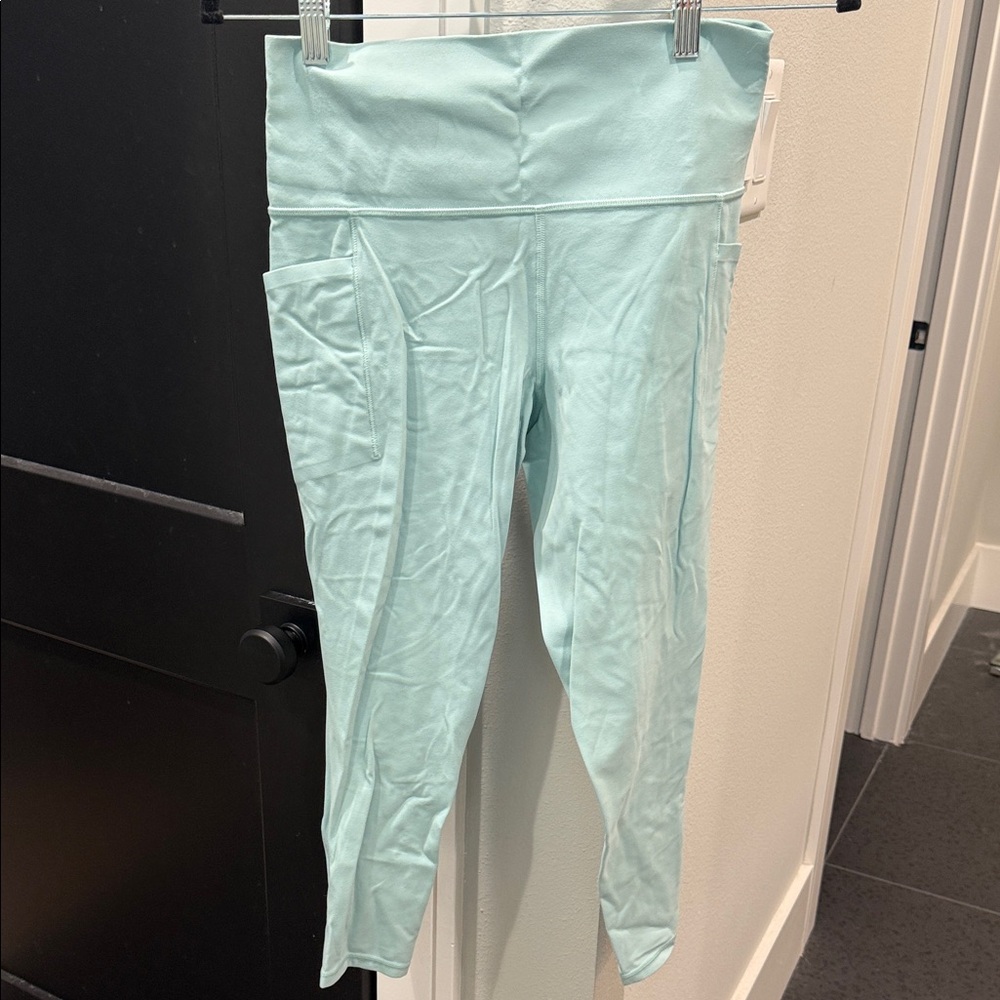blue athleta salutation stash pocket II 7/8 tight leggings size medium